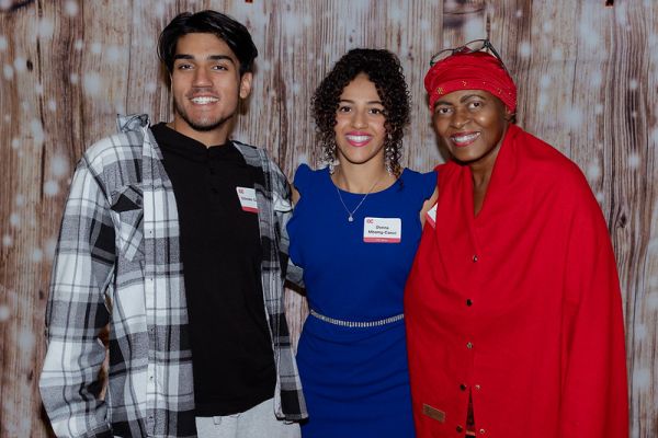 Photo of three people smiling.