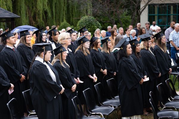 Students wearing graduation caps and gowns