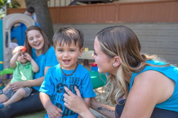 Young children smiling with care provider 