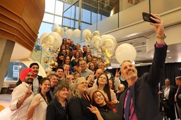 group of people on a stairway surrounded by balloons