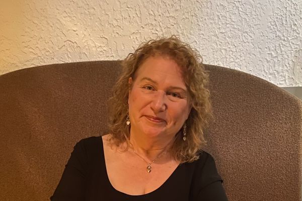 Photo of Denise Dickson sitting in a chair.