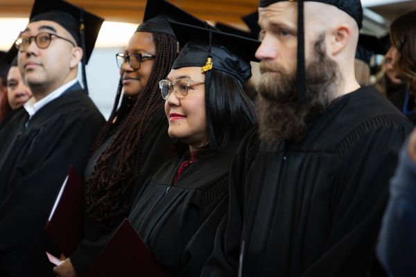 Students wearing graduation caps and gowns