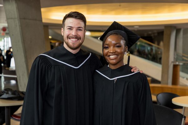 Two students pose for a photo during the spring 2022 convocation ceremony.