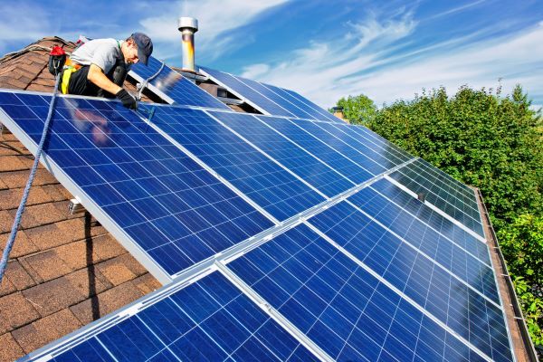 Clean Energy - photo of someone installing solar panels 