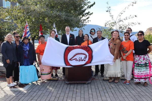 Celebrating the raising of the OKIB flag
