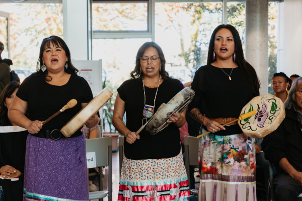 Three Indigenous women drumming at convocation 