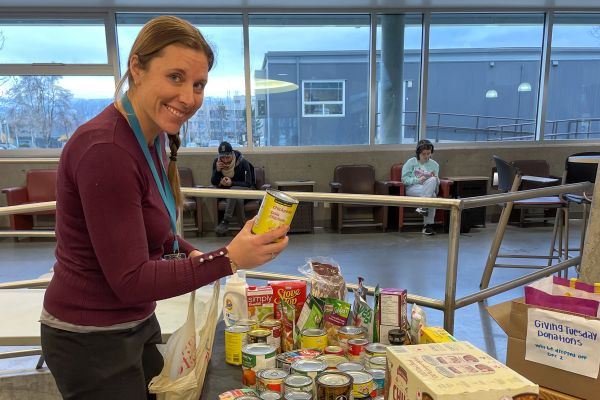 An OC employee drops off food donations on Giving Tuesday