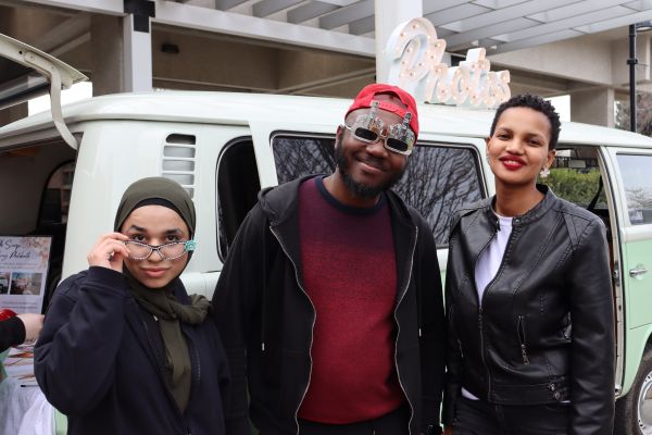 Students standing in front of the VW photo booth at an event