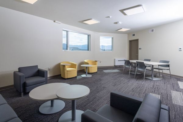 Kelowna student housing study room. Photo shows a room with comfortable chairs and spacious tables. 