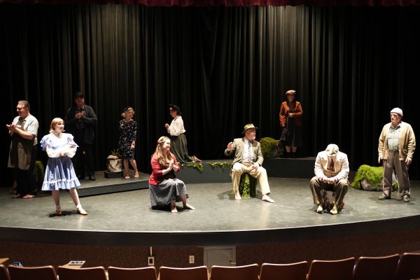 Red-Dot - West Moon cast stands on stage