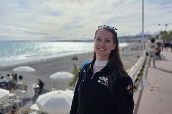 Katelyn at a port overlooking the beach and beach umbrellas