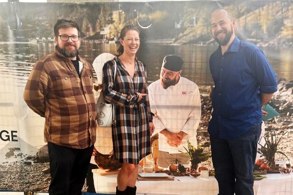 Josh, Jennifer and Nathan standing in front of the Centre for Food, Wine and Tourism banner