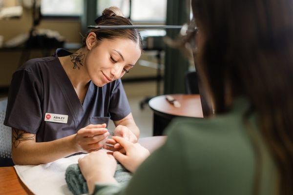 Esthetician doing a manicure on a client