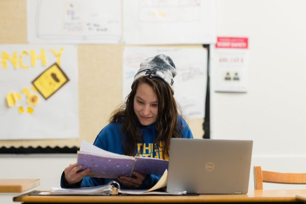 A student reading information from a folder