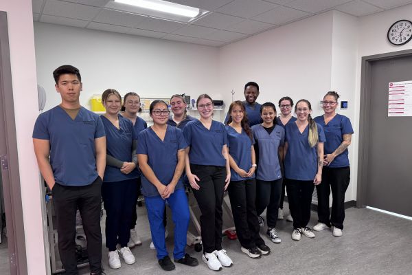 Okanagan College Nursing students wearing scrubs smile