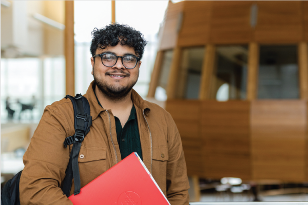 Student standing in front of the cocoon in the CFL building
