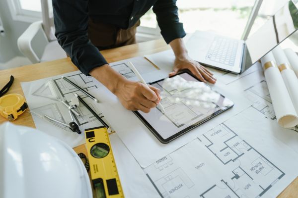 Person working on construction blue prints