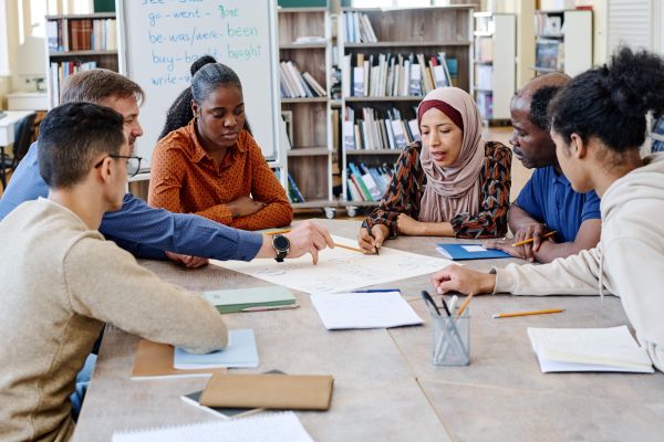 Students around a desk Getty