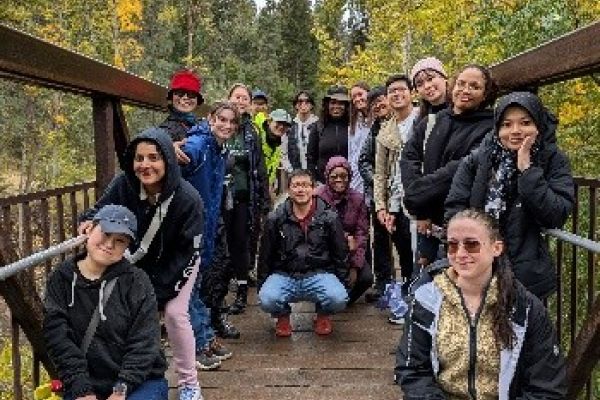 Students posing on a bridge 