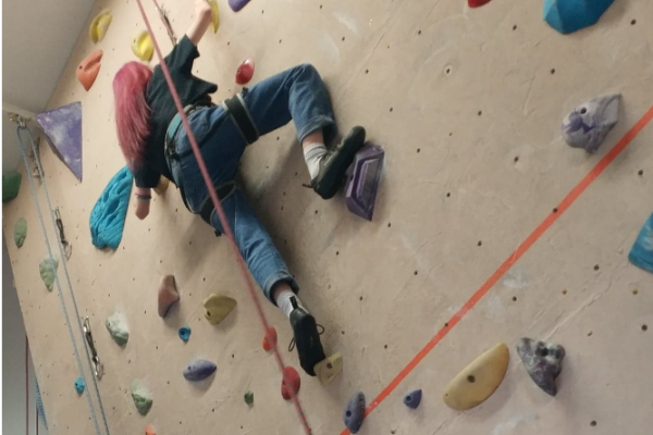 person on indoor rock climbing wall