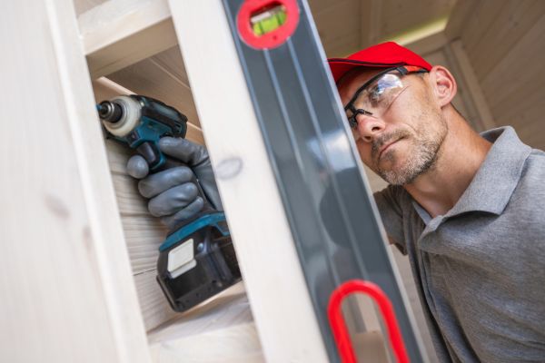 A person repairs a door frame