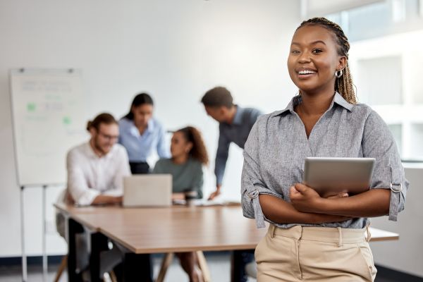 Person holding a tablet in a workplace meeting.