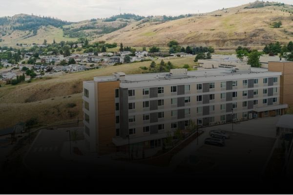 Exterior view of the student housing building overlooking the surrounding Okanagan landscape.