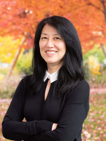 Geri Nishi International Division Assistant Fall trees in the background