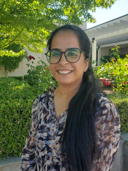 Gurleen with fall trees and bushes in the background