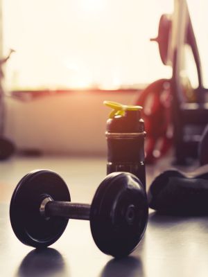 Exercising person sitting with gym equipment
