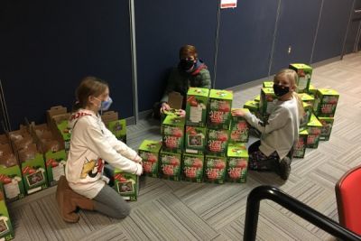 Elementary students pose socially distanced near Enactus FruitSnaps five litre juice boxes