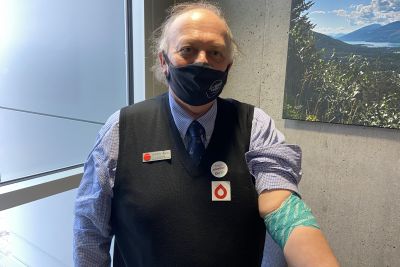 History Professor Howard Hisdal shows his bandage after he donated blood