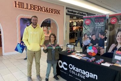 man with short brown hair and yellow sweater
