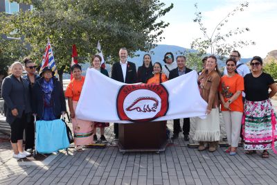 Celebrating the raising of the OKIB flag
