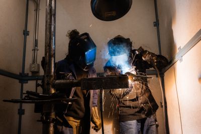 two welders work together