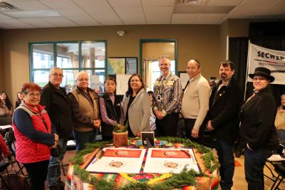 Event signatories posing with the House of Learning Parnership Agreement. From left: Kukpi7 Edna Felix of Splatsin, Kukpi7 Eddy Jules, Skeetchestn Indian Band, Tribal Kukpi7 Darrel Draney, Elder Lucy William, Kukpi7 Lynn Kenoras - Duck Chief, OC President Neil Fassina, Kukpi7 Frank Antoine, Bonaparte First Nation, Kukpi7 George Lampreau, Simpcw First Nation, Sunny Lebourdais of Whispering Pines/Clinton Indian Band.