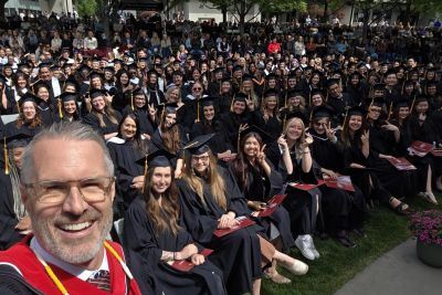 OC President Dr. Neil Fassina takes a selfie with students at the College's convocation event June 6.
