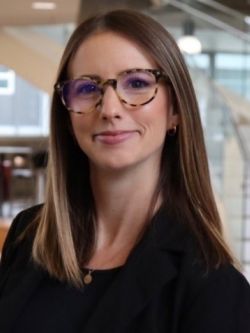 woman with medium length brown hair and glasses