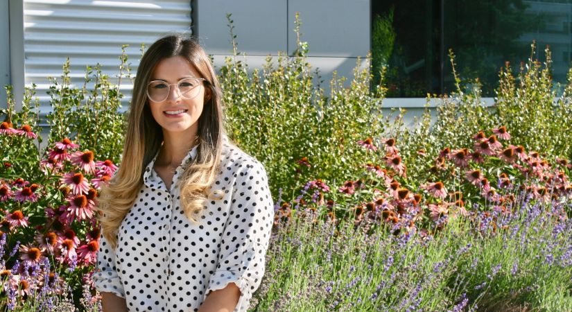 ESL student Katia Aguila takes a break from classes to enjoy flowers in the garden