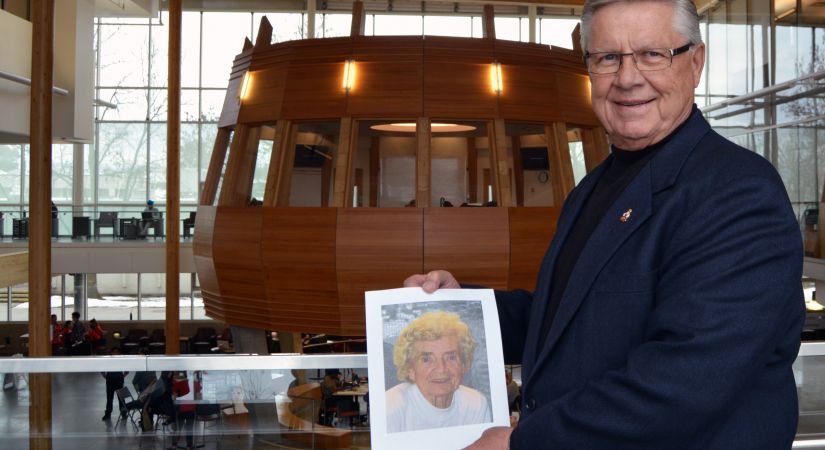 John Sokolowski holding a picture of his mother, Janina