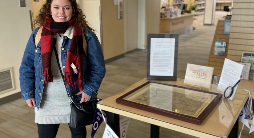 Maddy Moss examining the map on display at the Kelowna campus