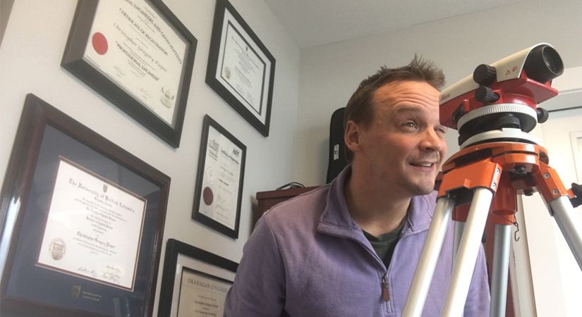 Civil Engineering Professor Chris Pieper looks through surveying equipment
