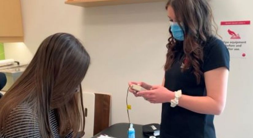 Vanessa Marshall (right) practicing her skills on fellow Therapist Assistant student Hannah Koch