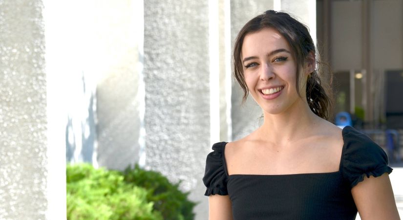Engineering student Bella Cotton stands outside of the Lab Building in between classes.