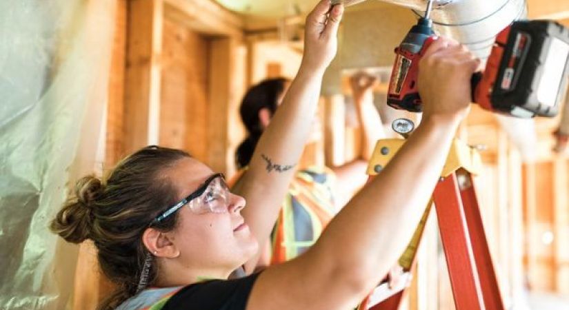 female salmon arm plumbing student working on demo at trades center