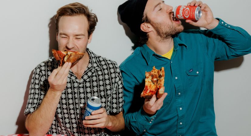 Nonny Beer owners eat slices of pieces while sipping non-alcoholic beverages