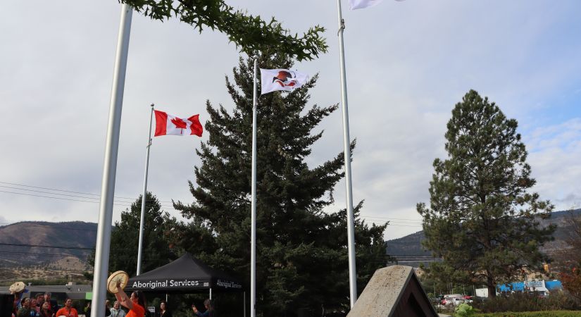 ona and pib flags raised, drummers singing in the background