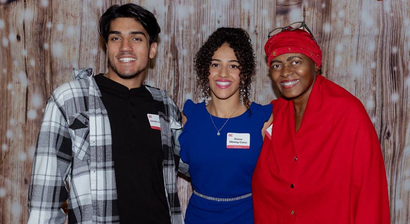 Photo of three people smiling.