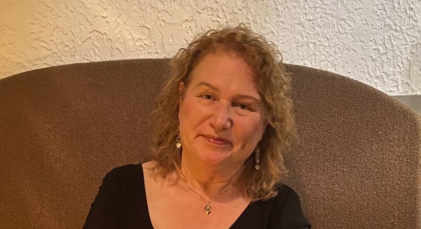 Photo of Denise Dickson sitting in a chair.