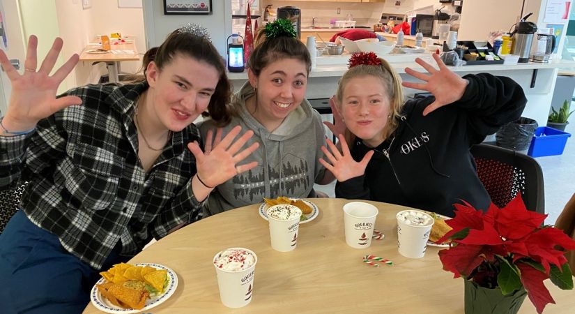three students sitting around a table